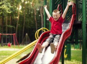 Active boy sliding down