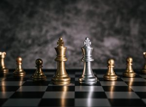 Gold and Silver Chess on chess board game for business metaphor leadership concept