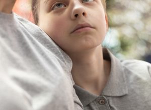 Mother and adolescent reconciliating during therapy session, loving family and unconditional love. Mom hugging her offspring and accepting her as she is, showing affection. Close up.