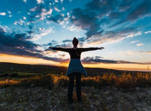 A silhouette shot of a young female hiker in the countryside in Spain
