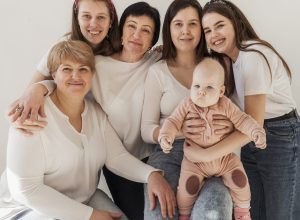 women-white-shirts-posing-together-baby