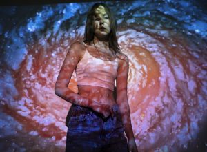 young-woman-standing-universe-texture-projection